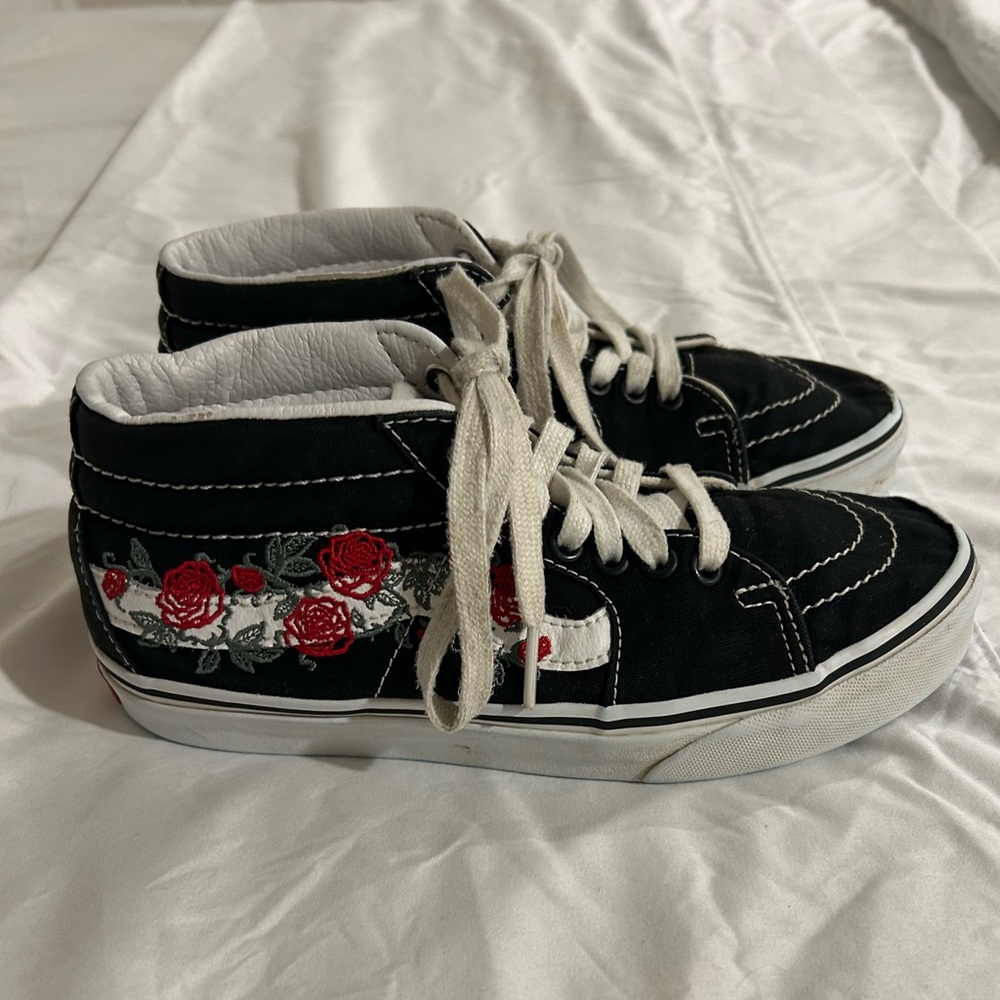 Vans women’s size 7 black high tops with roses.